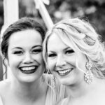Two emotional bridesmaids in black and white at a backyard wedding in La Crosse.