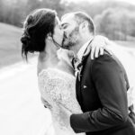 A bride and groom kissing at their love-filled backyard wedding.