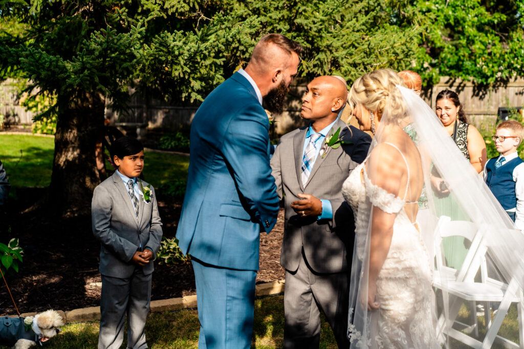 A bride and groom exchanging emotional vows in a backyard wedding ceremony in La Crosse.