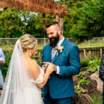 A heartfelt bride and groom exchange rings during their emotional outdoor wedding ceremony in La Crosse.