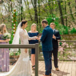 Courtney and James exchange vows on a wooden deck at their love-filled wedding.