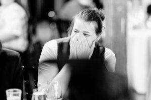 A woman is crying while sitting at a table.