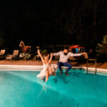 A couple joyfully celebrates with a nighttime plunge during their emotional backyard wedding in La Crosse.