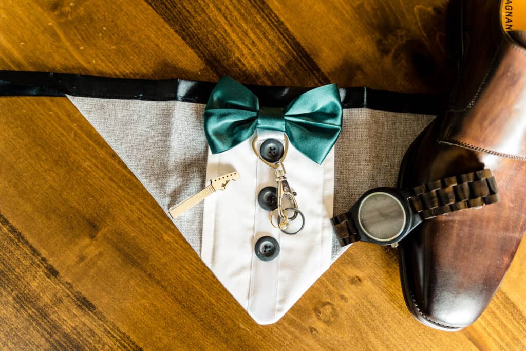 A bow tie and a watch on a table.