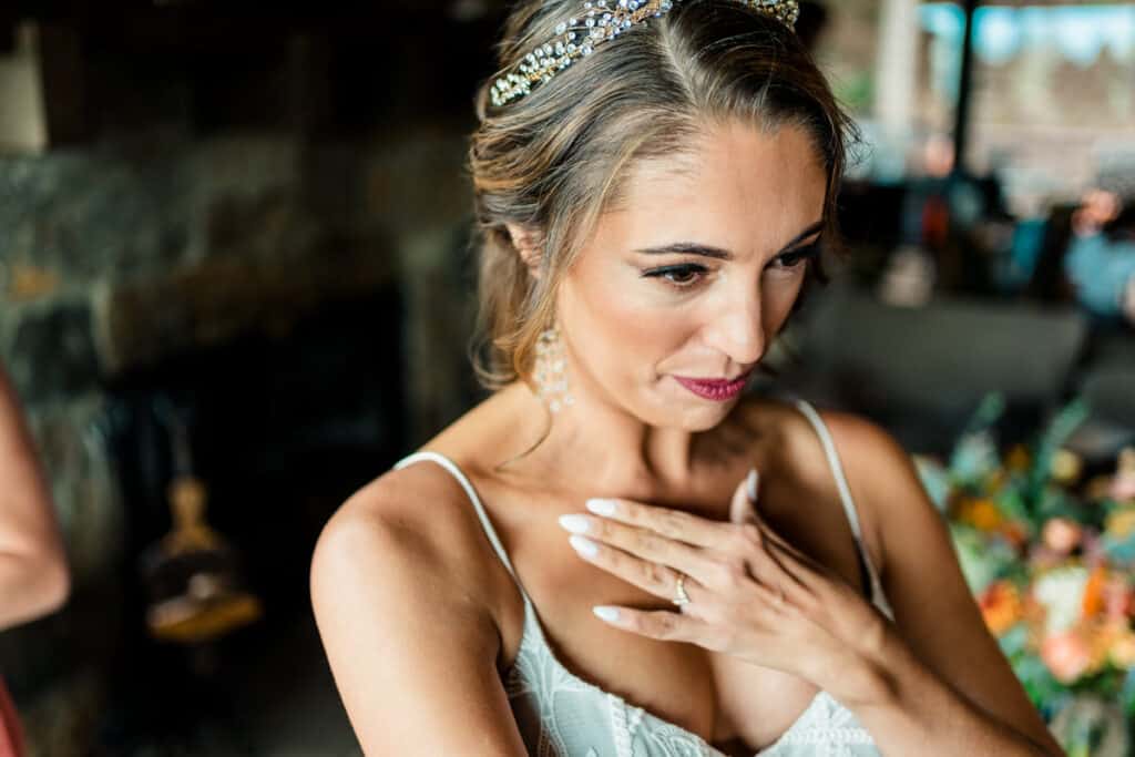 A bride is putting on her wedding tiara.