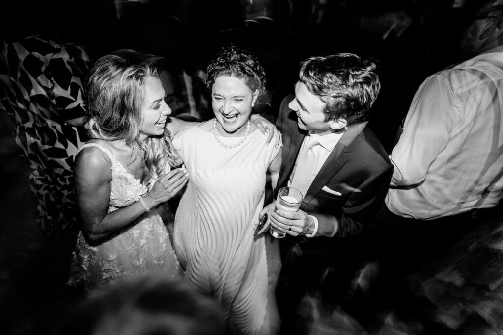 A black and white photo of a group of people at a party.