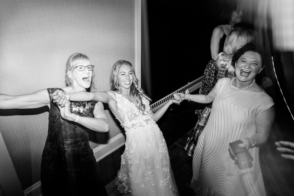 A group of women dancing in a black and white photo.