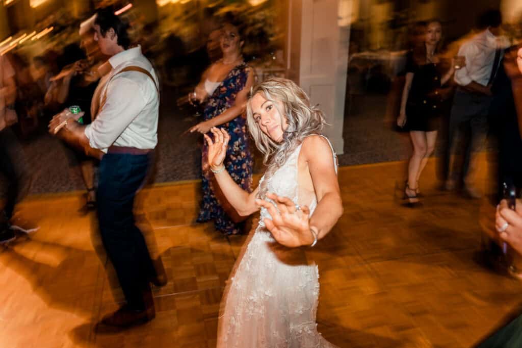 A bride dancing on the dance floor at a wedding reception.