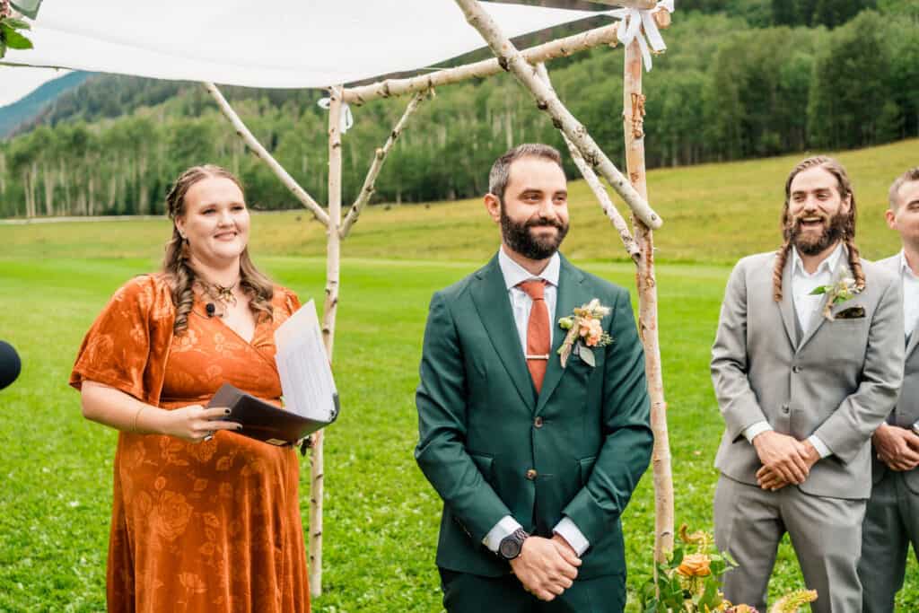 A wedding ceremony in the mountains with a bride and groom.