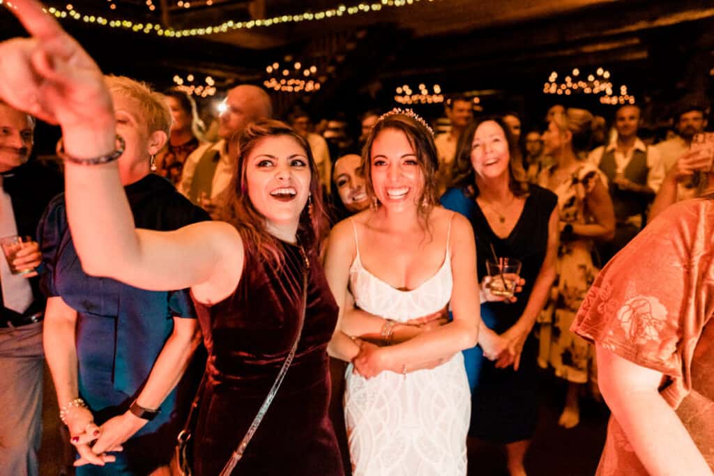 A bride and groom taking a selfie at a wedding reception.