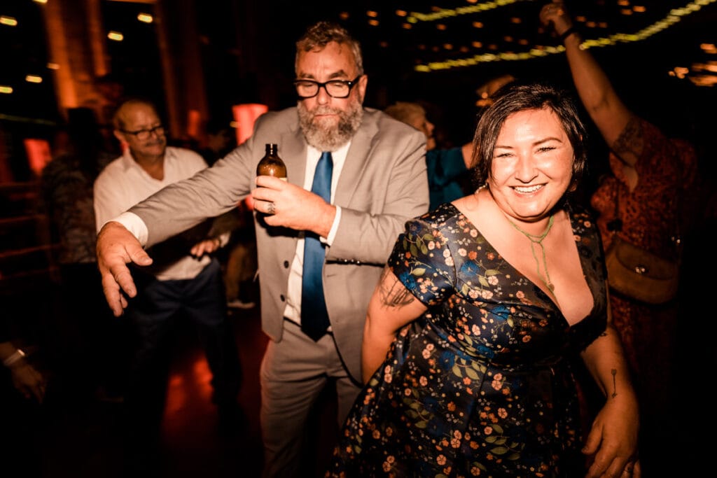 A man and woman dancing at a wedding reception.