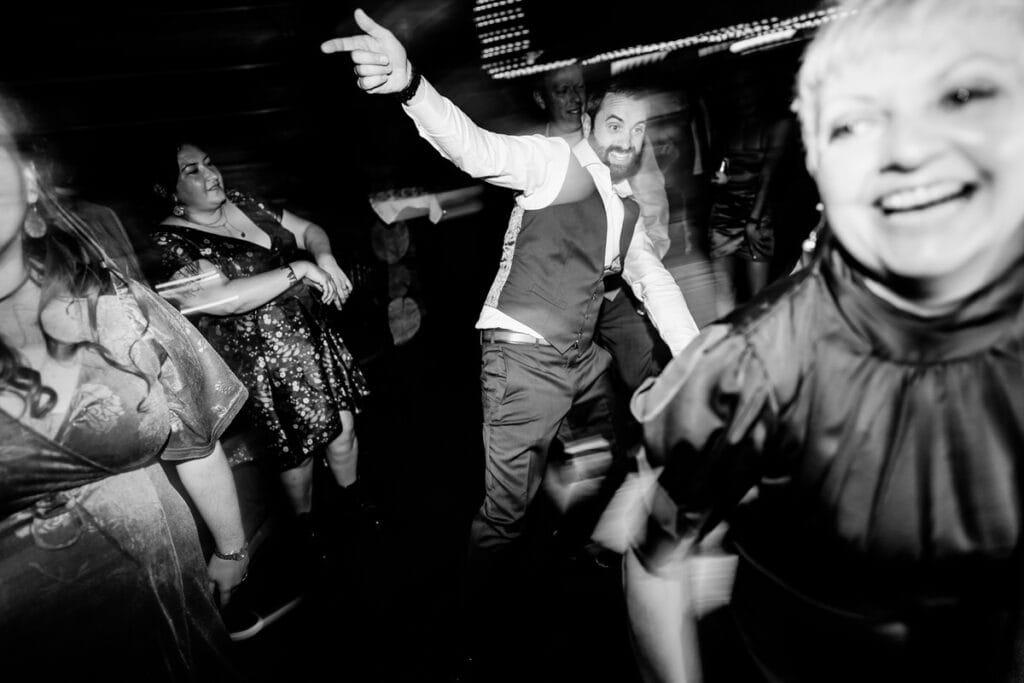 A black and white photo of people dancing at a party.