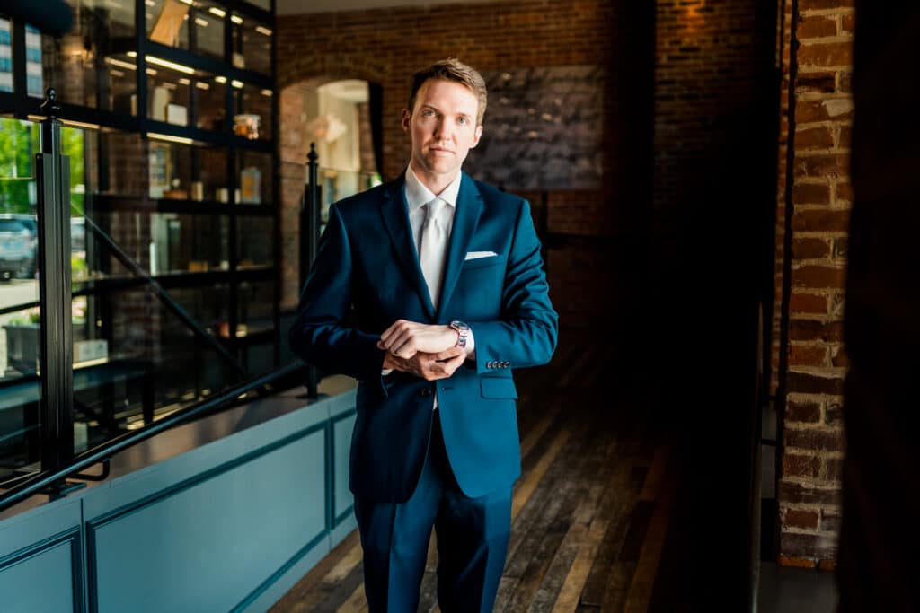 A man in a suit standing in a room.