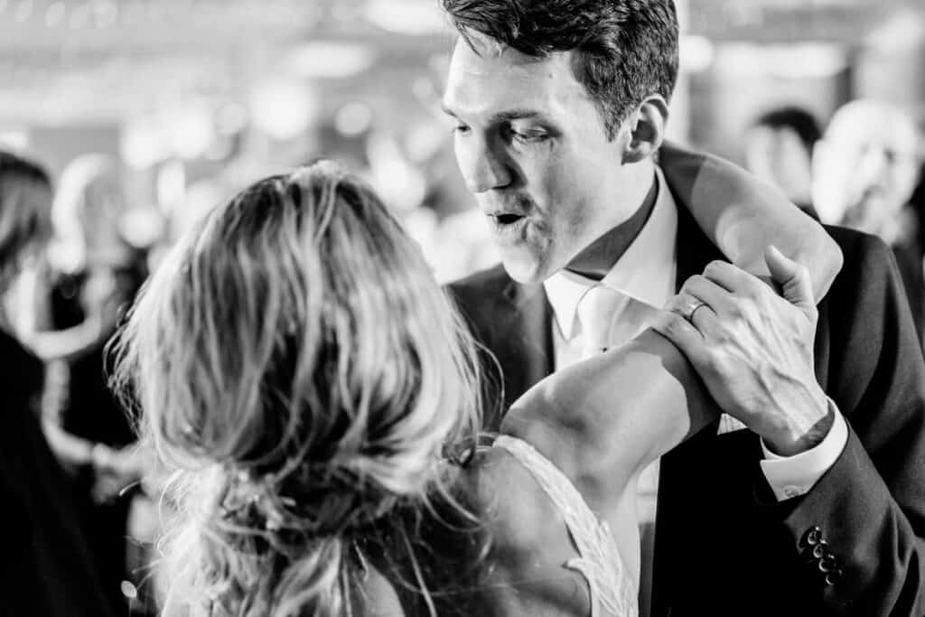 A bride and groom dancing at a wedding reception.