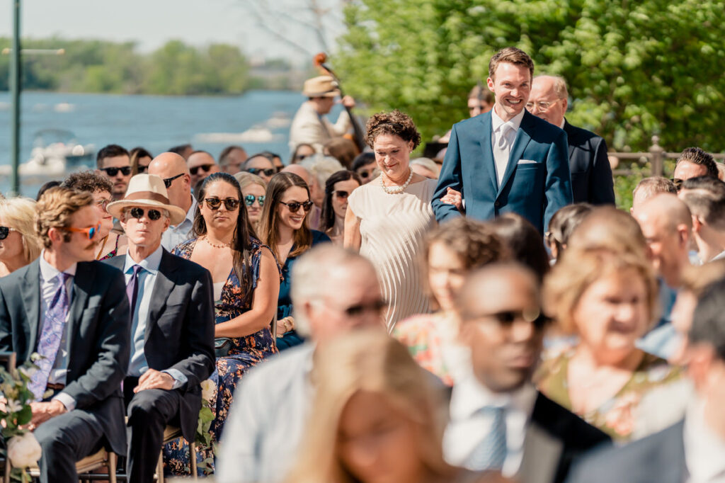 A group of people walking down the aisle at a wedding ceremony.