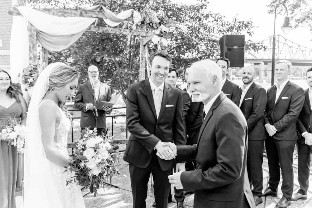 A black and white photo of a wedding ceremony.