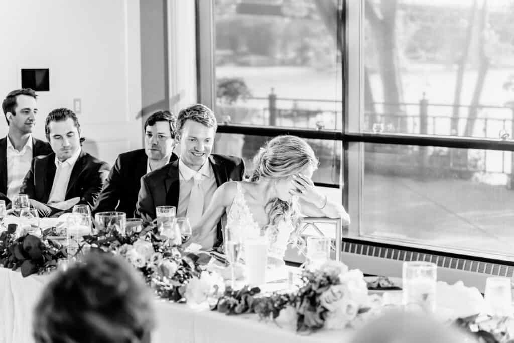 A black and white photo of a group of people sitting at a table.