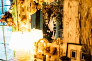 A bride and groom standing in front of a mirror.