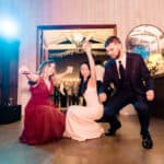 A group of people dancing at a wedding reception.