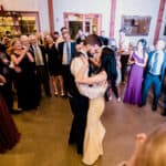 A bride and groom sharing their first dance at a wedding reception.