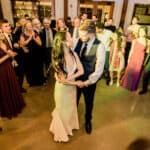 A bride and groom sharing their first dance at a wedding reception.