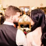 A bride and groom looking at each other at a wedding reception.