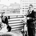A black and white photo of a wedding ceremony on a rooftop.