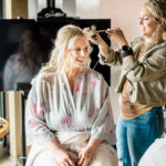 A bride getting her hair done in a salon.