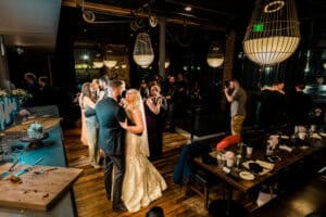 A bride and groom dance at a wedding reception.