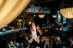 A bride and groom sharing their first dance in a restaurant.