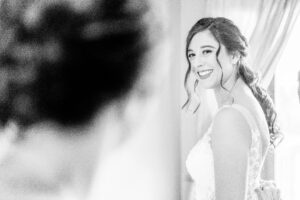 A bride smiles as she gets ready for her wedding.