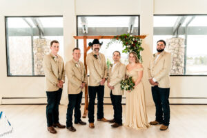 A group of groomsmen and bridesmaids posing for a photo.