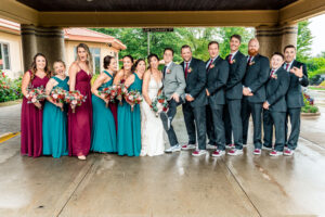 A group of bridesmaids and groomsmen posing for a photo.