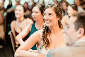 A bride smiles at a wedding reception.