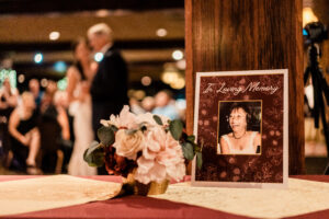 A photo of a woman is on a table at a wedding reception.