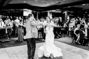 A bride and groom sharing their first dance at a wedding reception.