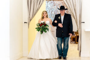 A bride and her father walking down the aisle.