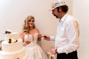 A bride and groom cutting a wedding cake.