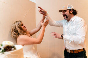 A bride and groom giving each other a high five.