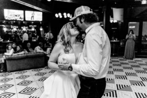 A bride and groom sharing their first dance in a bar.