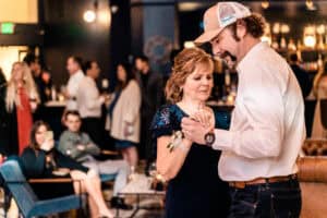 A man and woman dancing at a party.