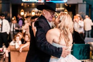 A bride and groom dance at a wedding reception.