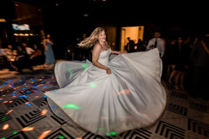 A bride dancing on the dance floor at a wedding reception.