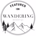 Black and white circular badge with "Featured on Wandering Weddings" text, illustrated mountains, and pine trees inside the circle—perfect for a La Crosse wedding photographer’s portfolio.